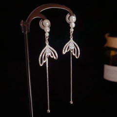 Angled view of the 14K Gold-Plated Elegant Pearl Zircon Fishtail Tassel Earrings