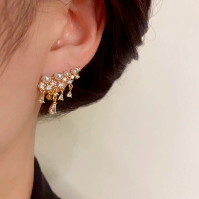 Model showcasing the dangle and style of the 14K Gold-Plated Elegant Pearl Zircon Tassel Earrings