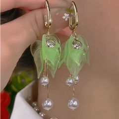 Model showcasing the dangle and style of the 14K Gold-Plated Elegant Petal Pearl Tassel Earrings