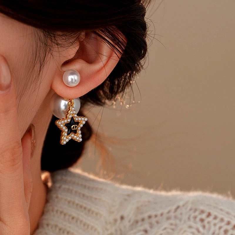 Model showcasing the dangle and style of the 14K Gold-Plated Elegant Pig Nose Star Pearl Earrings