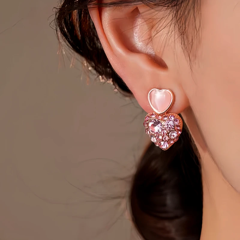 Model showcasing the dangle and style of the 14K Gold-Plated Elegant Pink Diamond Heart Earrings