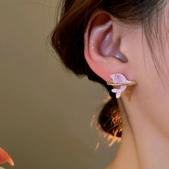 Close-up detail of the sparkling zircons and plating on the Pink Dolphin Studs