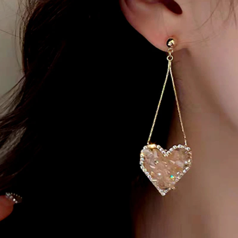 Close-up detail of the sparkling zircons and plating on the Pink Heart Tassel Earrings