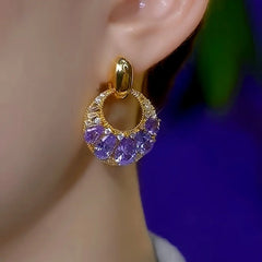 Model showcasing the dangle and style of the 14K Gold-Plated Elegant Purple Diamond Tassel Earrings