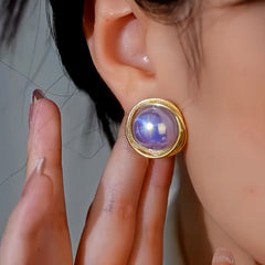 Model showcasing the dangle and style of the 14K Gold-Plated Elegant Purple Pearl Stud Earrings