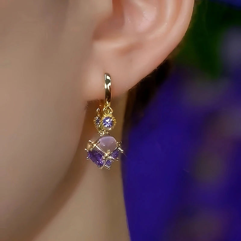 Model showcasing the dangle and style of the 14K Gold-Plated Elegant Purple Zircon Diamond Cat's Eye Stone Tassel Earrings