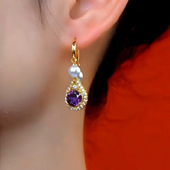 Model showcasing the dangle and style of the 14K Gold-Plated Elegant Purple Zircon Diamond Pearl Tassel Earrings