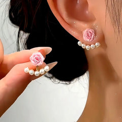 Model showcasing the dangle and style of the 14K Gold-Plated Elegant Red And Pink Rose Pearl Jacket Earrings