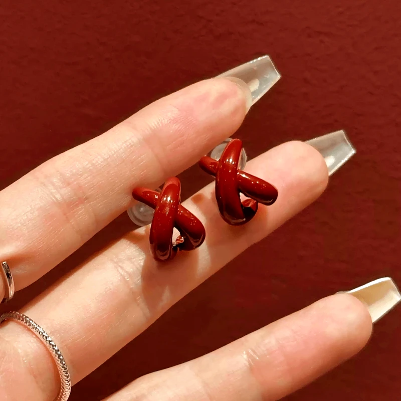 Angled view of the 14K Gold-Plated Elegant Red Cross Irregular Earrings