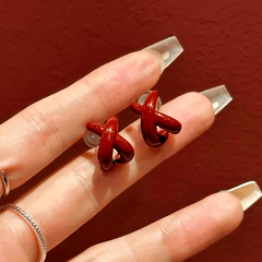 Angled view of the 14K Gold-Plated Elegant Red Cross Irregular Earrings