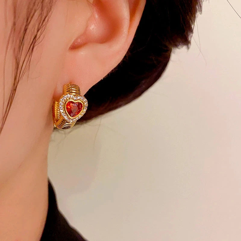 Close-up detail of the sparkling zircons and plating on the Red Heart Hoop Earrings