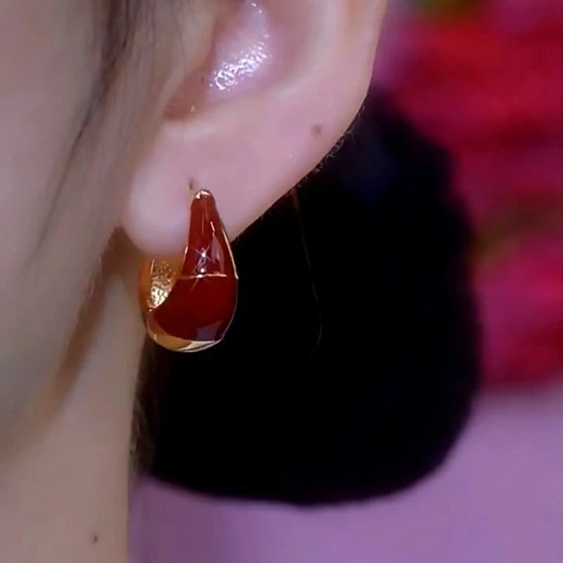 Close-up detail of the sparkling zircons and plating on the Red Oil Drop Earrings