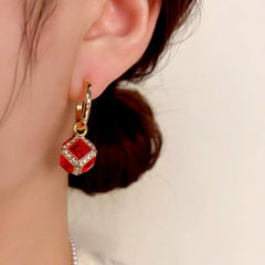 Close-up detail of the sparkling zircons and plating on the Red Zircon Cube Earrings