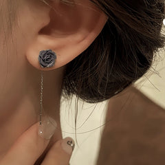 Model showcasing the dangle and style of the 14K Gold-Plated Elegant Resin Black Flower Threader Earrings