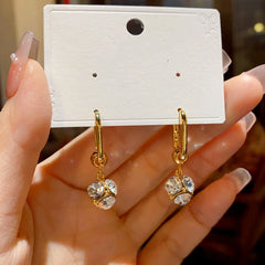 Close-up detail of the sparkling zircons and plating on the Rhinestone Ball Earrings
