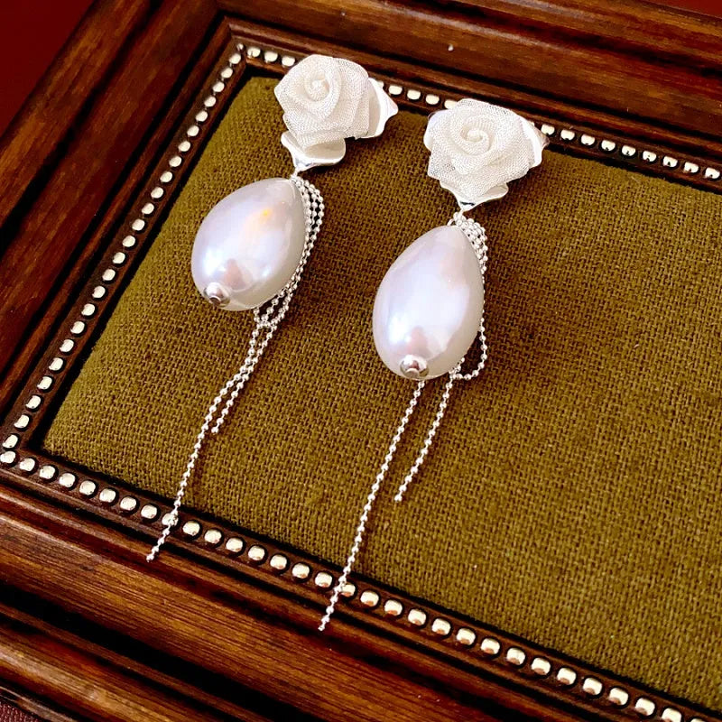 Angled view of the 14K Gold-Plated Elegant Rose Pearl Tassel Earrings