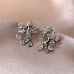 Angled view of the 14K Gold-Plated Elegant Round Pattern Leaf Tassel Earrings