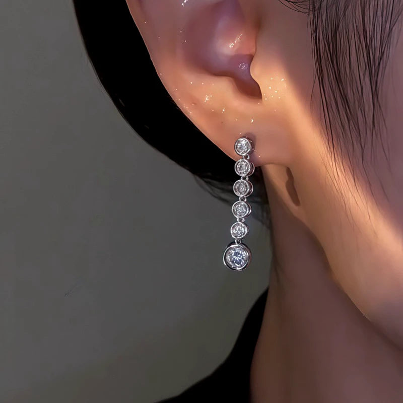 Model showcasing the dangle and style of the 14K Gold-Plated Elegant Round Zircon Tassel Earrings
