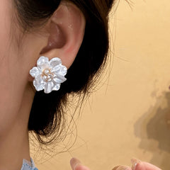 Close-up detail of the sparkling zircons and plating on the Flower Pearl Studs
