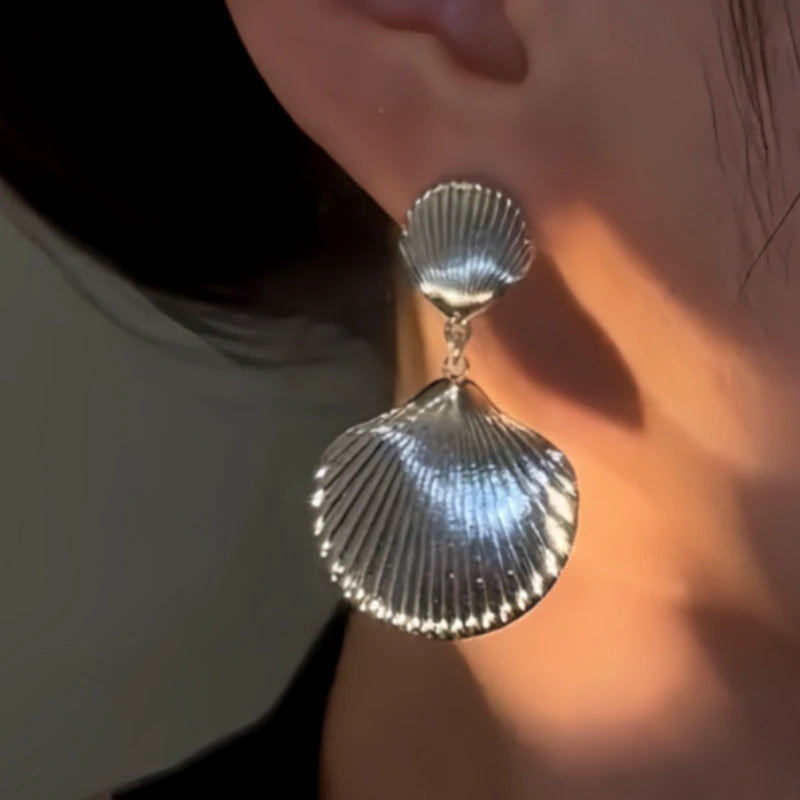 Close-up detail of the sparkling zircons and plating on the Shell Tassel Earrings