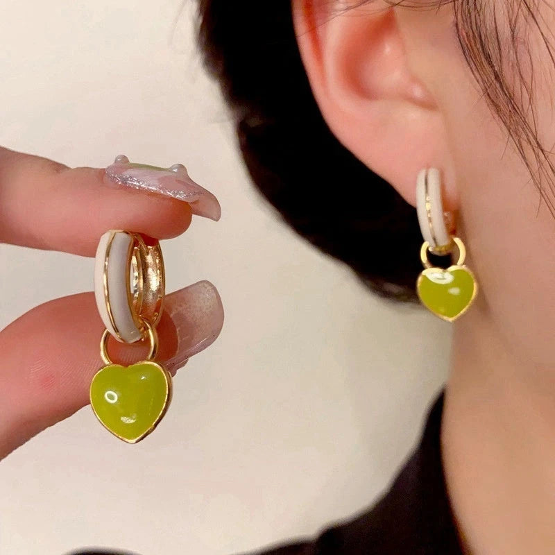 Close-up detail of the sparkling zircons and plating on the Green Heart Earrings