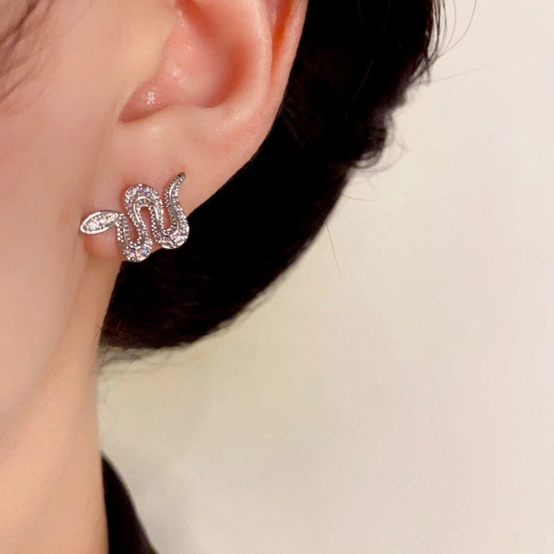 Model showcasing the dangle and style of the 14K Gold-Plated Elegant Snake Stud Earrings