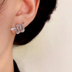 Model showcasing the dangle and style of the 14K Gold-Plated Elegant Snake Stud Earrings