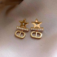Angled view of the 14K Gold-Plated Elegant Star Pearl Earrings
