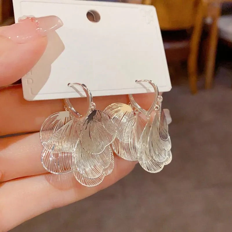 Model showcasing the dangle and style of the 14K Gold-Plated Elegant Tassel Earrings