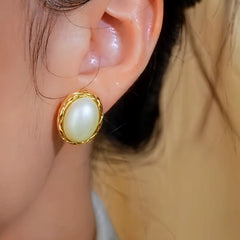 Close-up detail of the sparkling zircons and plating on the Oval Pearl Studs