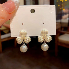 Close-up detail of the sparkling zircons and plating on the Clover Pearl Earrings