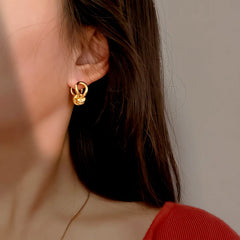Close-up detail of the sparkling zircons and plating on the Knotted Dangle Earrings
