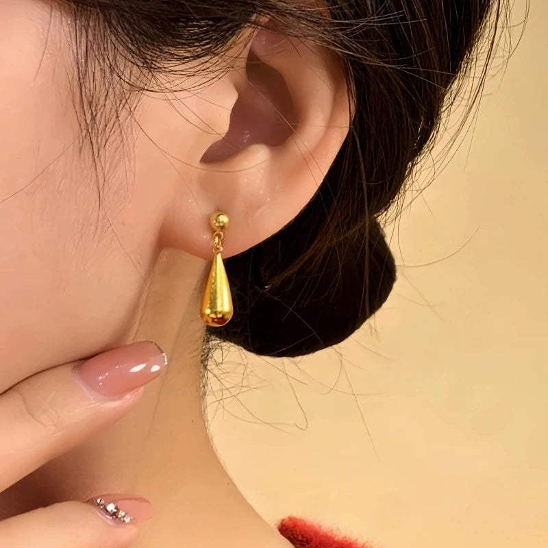 Model showcasing the dangle and style of the 14K Gold-Plated Elegant Water Drop Earrings