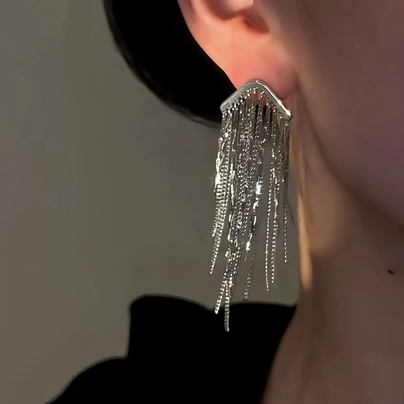 Model showcasing the dangle and style of the 14K Gold-Plated Elegant Waterfall Chain Tassel Earrings
