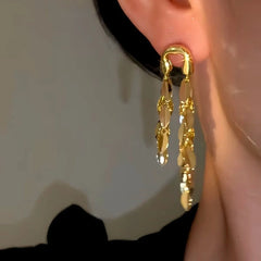 Model showcasing the dangle and style of the 14K Gold-Plated Elegant Wheat Tassel Earrings