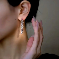 Model showcasing the dangle and style of the 14K Gold-Plated Elegant Wheat Tassel Earrings