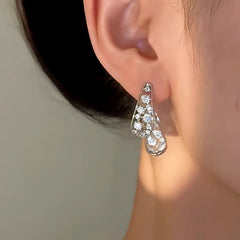 Model showcasing the dangle and style of the 14K Gold-Plated Elegant Zircon Autumn Leaf Earrings