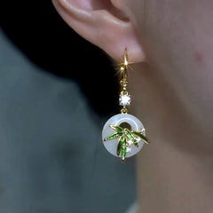 Model showcasing the dangle and style of the 14K Gold-Plated Elegant Zircon Bamboo Leaf Earrings