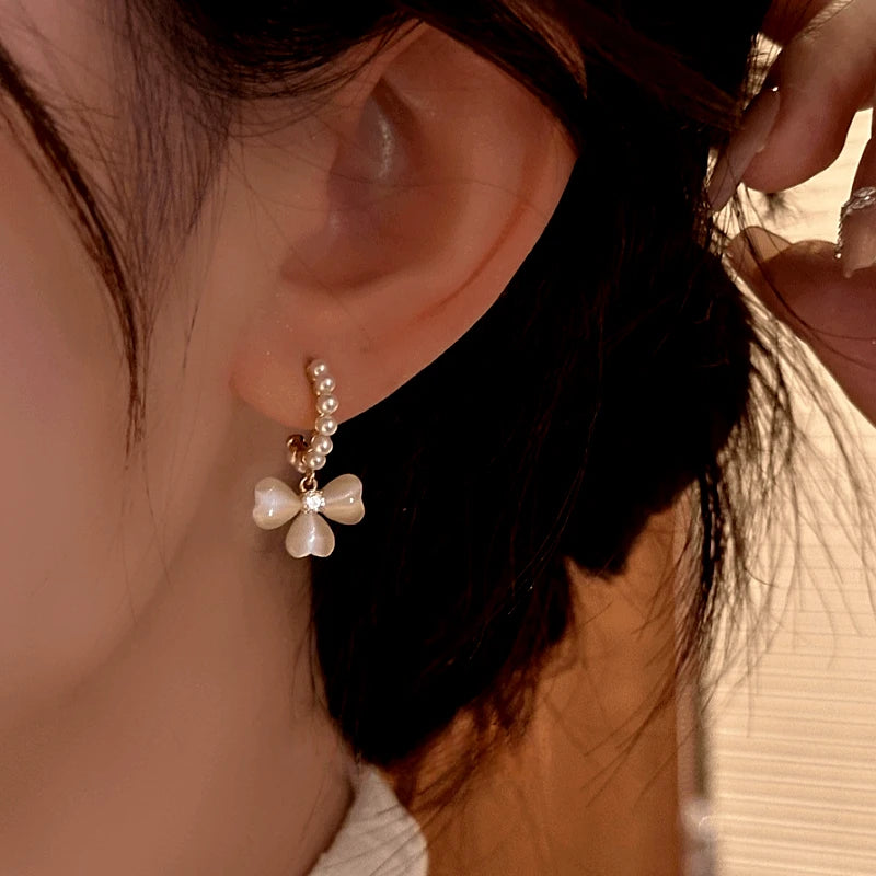 Close-up detail of the sparkling zircons and plating on the Cat's Eye Flower Earrings