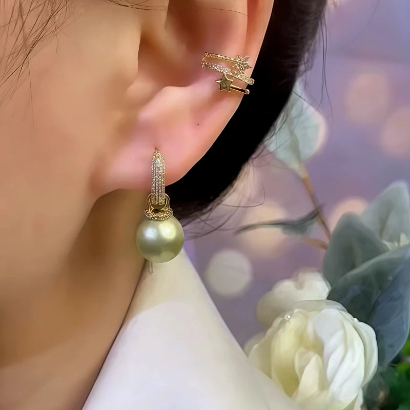 Model showcasing the dangle and style of the 14K Gold-Plated Elegant Zircon Bead Earrings
