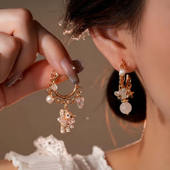 Angled view of the 14K Gold-Plated Elegant Zircon Bear Bead Star Tassel Earrings