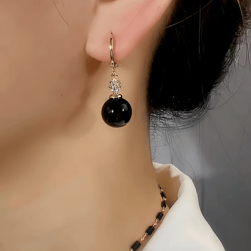 Close-up detail of the sparkling zircons and plating on the Black Bead Earrings