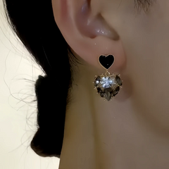 Model showcasing the dangle and style of the 14K Gold-Plated Elegant Zircon Black Diamond Heart Earrings