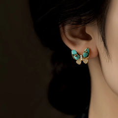 Model showcasing the dangle and style of the 14K Gold-Plated Elegant Zircon Green Butterfly Stud Earrings