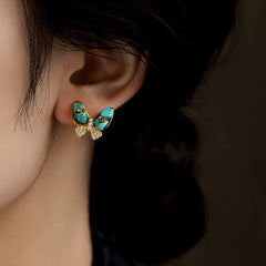 Close-up detail of the sparkling zircons and plating on the green butterfly earrings