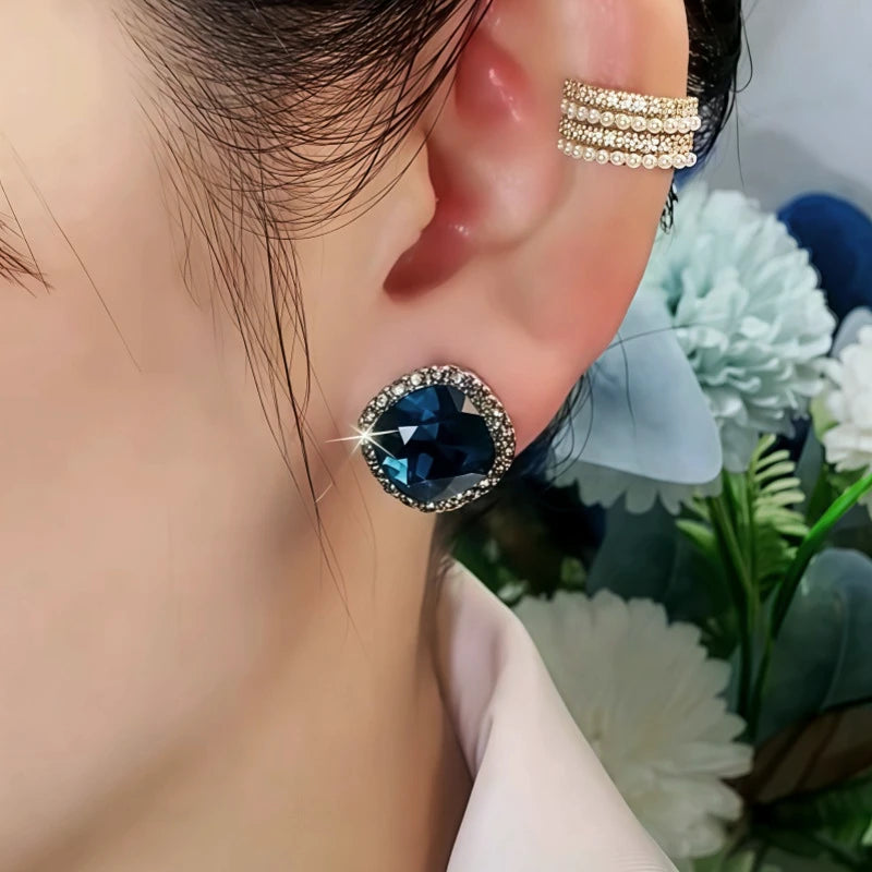 Model showcasing the dangle and style of the 14K Gold-Plated Elegant Zircon Blue Crystal Earrings