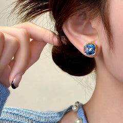 Close-up detail of the sparkling zircons and plating on the Blue Zircon Studs