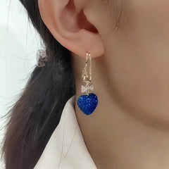 Model showcasing the dangle and style of the 14K Gold-Plated Elegant Zircon Blue Heart Earrings