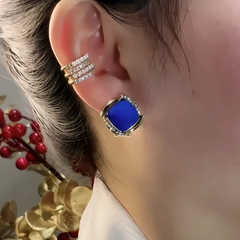 Model showcasing the dangle and style of the 14K Gold-Plated Elegant Zircon Blue Square Stud Earrings