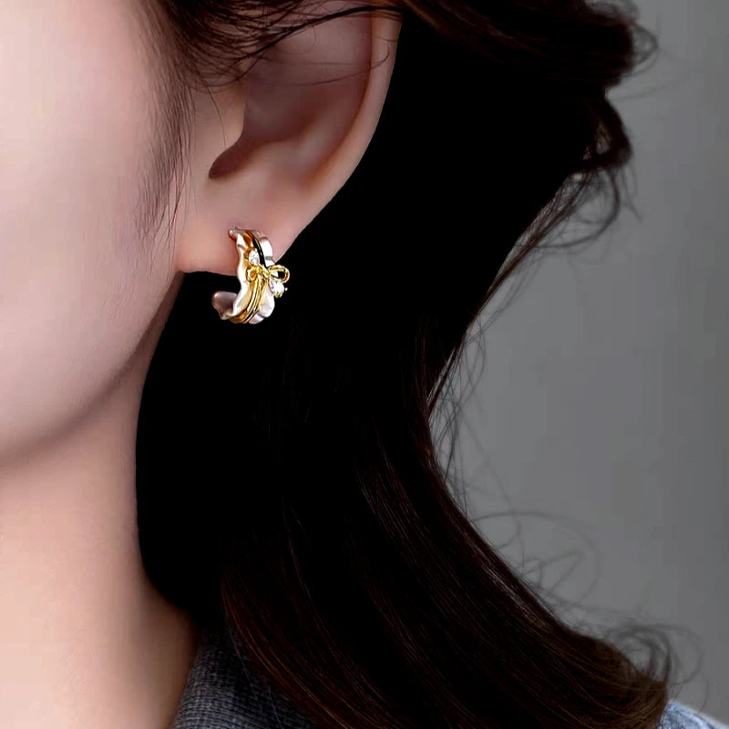 Close-up detail of the sparkling zircons and plating on the Bow Hoop Earrings